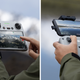 A user pressing the screen of the DJI RC remote controller and second pic of a user at the controls of the DJI RC-N1 remote controller.